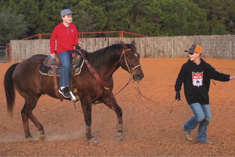 Jackson and Walker riding special team roping horse Bob