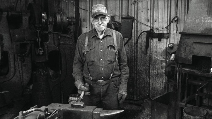 Billy Klapper stands at his workbench in his shop. Photography by Ross Hecox.