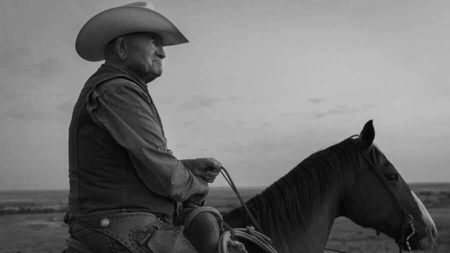 Boots O'Neal horseback on the Four Sixes Ranch in black and white